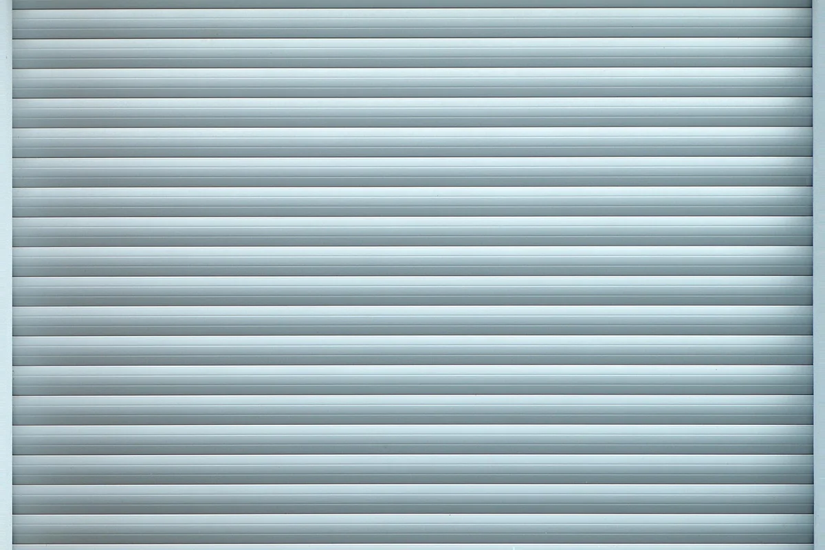 Closed gray metal garage door with horizontal panels