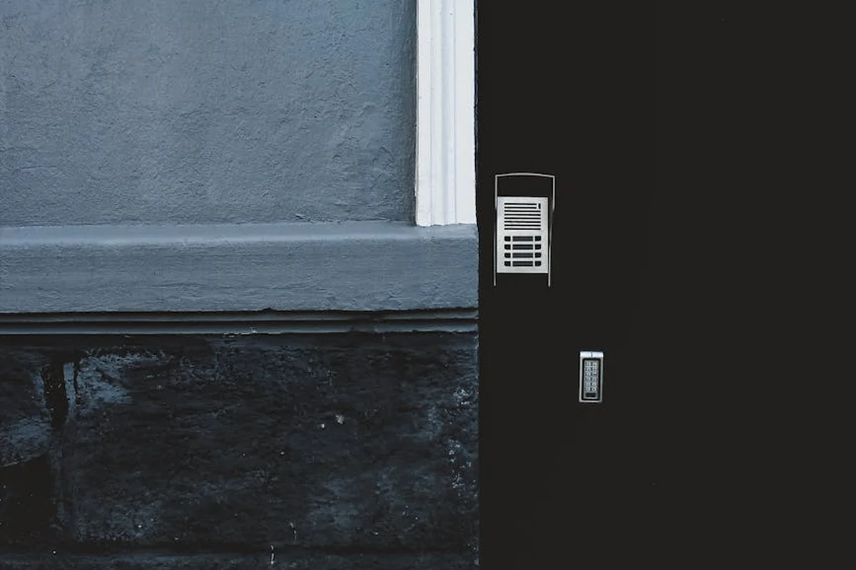Exterior door with a mounted keypad and intercom panel.