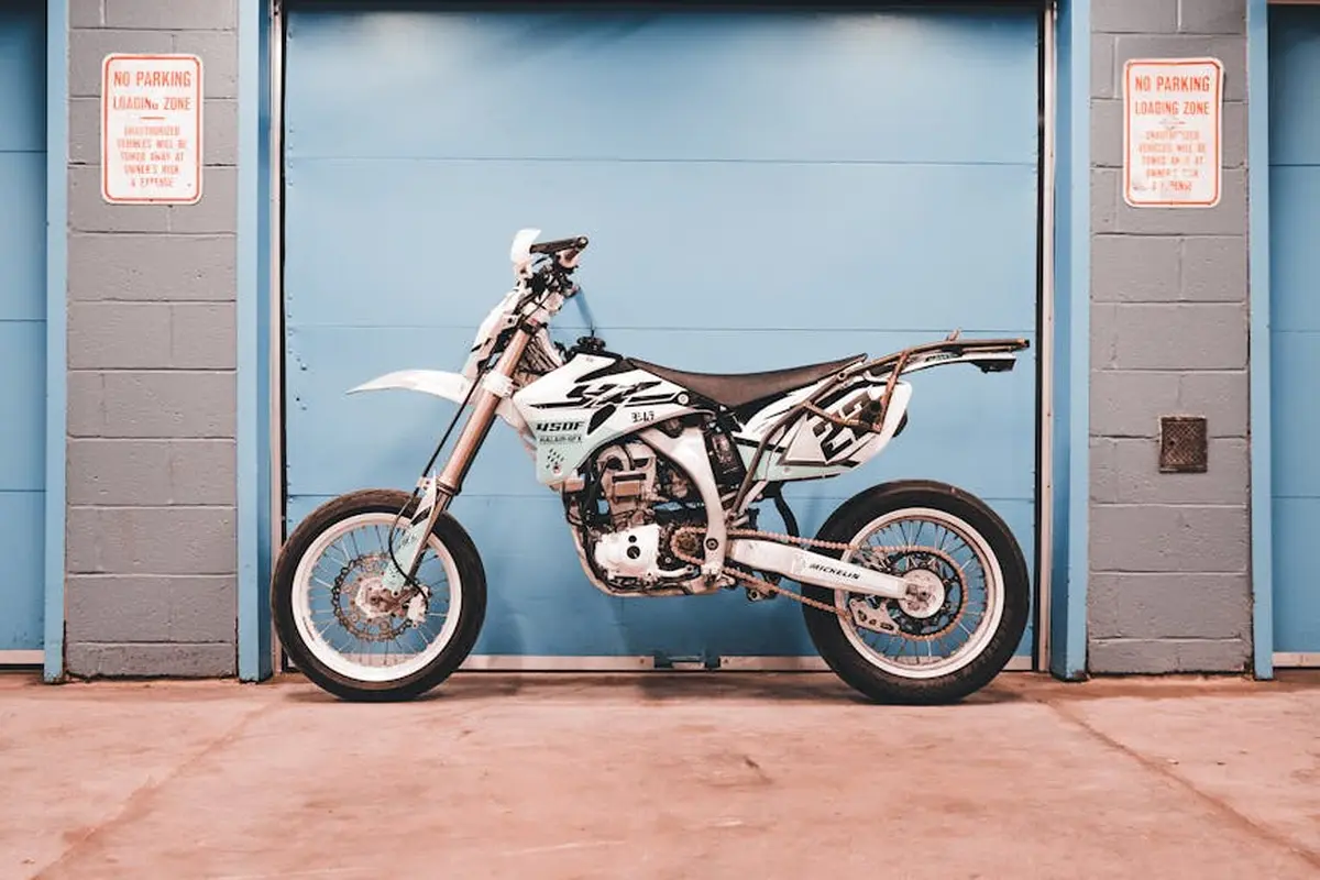 Motorcycle parked in front of a blue garage door