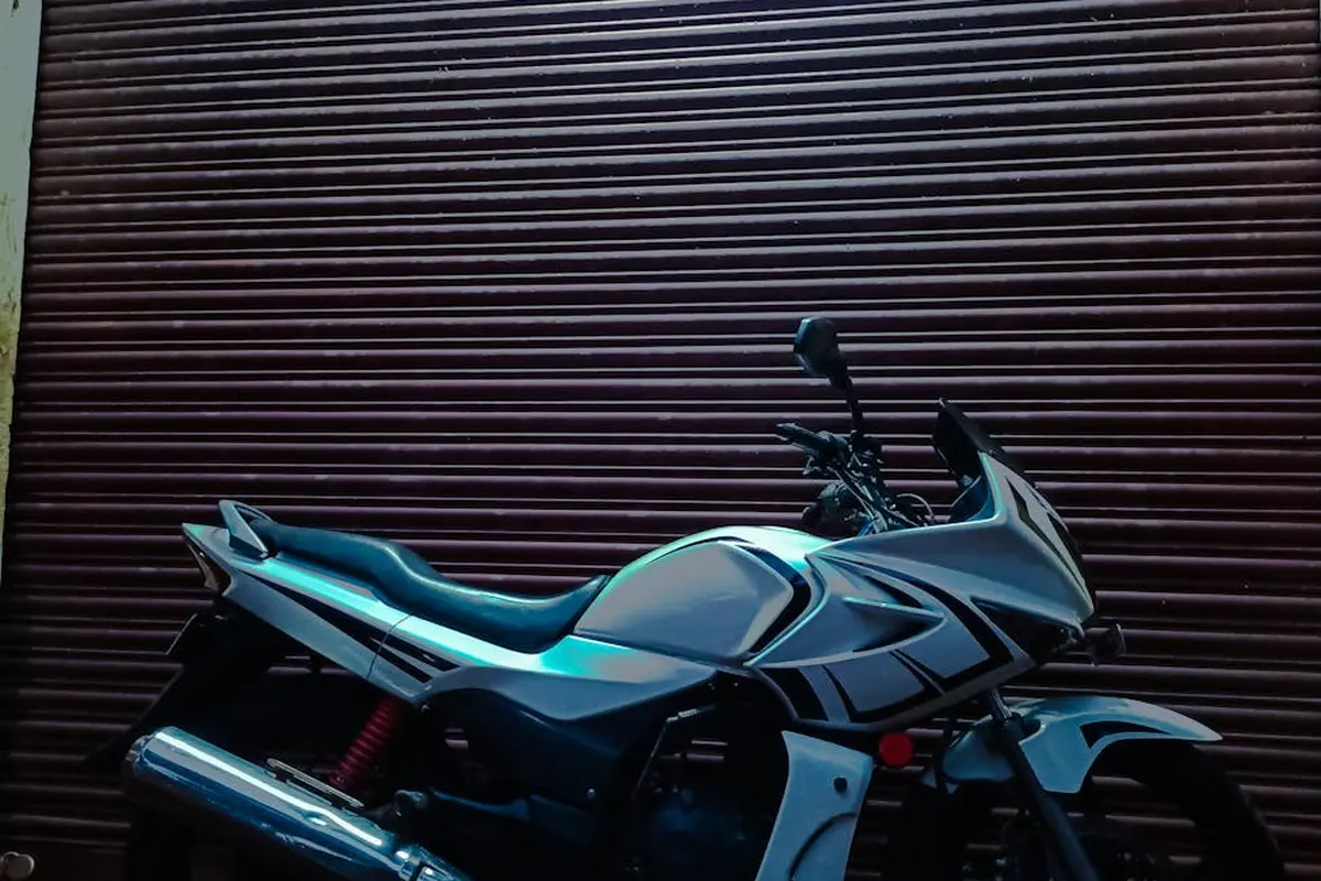 Motorcycle parked in front of a closed brown metal garage door.