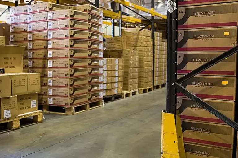 Warehouse shelves and palletized boxes arranged for organized storage and easy access.