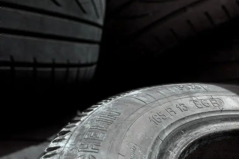 Close-up of stacked tires in a dimly lit garage