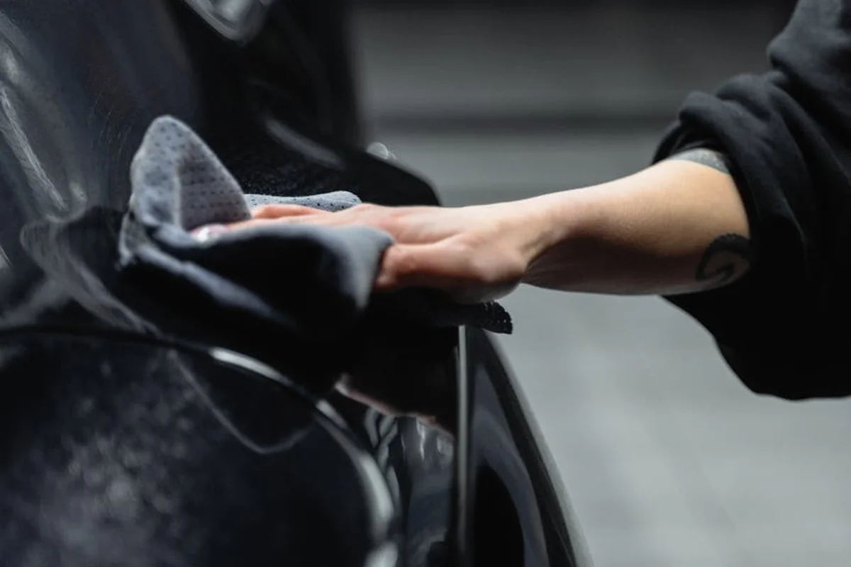 Close-up of a hand reaching into a car door, illustrating an intrusion into a garage space.