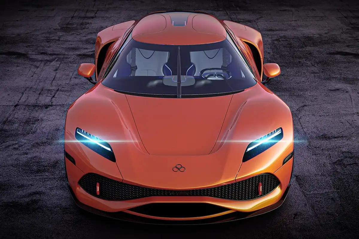 Front view of an orange electric vehicle in a dim garage, highlighting its sleek, aerodynamic design.