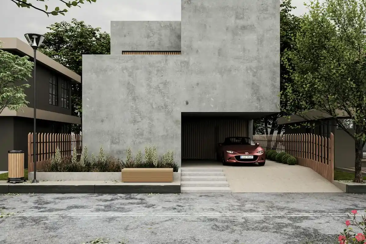 Modern concrete garage shell with an open entry and a car parked inside, surrounded by a small front yard with plants and a wooden fence.