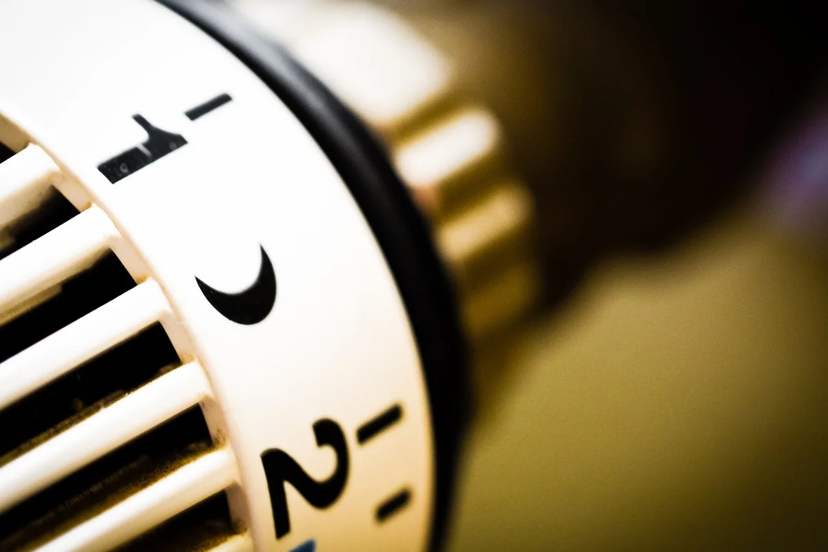 Close-up of a thermostat dial with temperature numbers