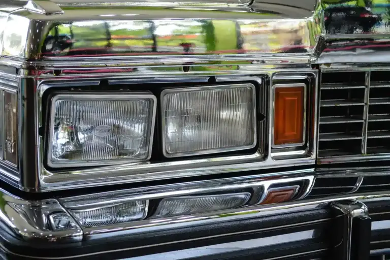 Close-up of a full-size truck's chrome front end with headlights and amber turn signal