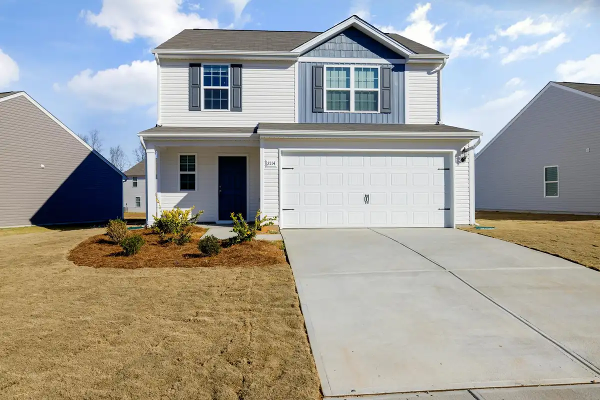 Modern suburban home with a two-car attached garage and a concrete driveway