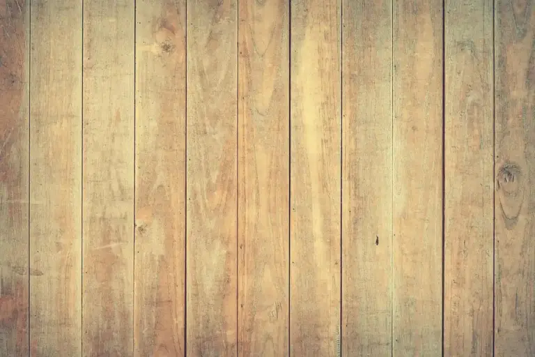 Vertical wooden planks with warm brown tones forming a rustic floor texture.