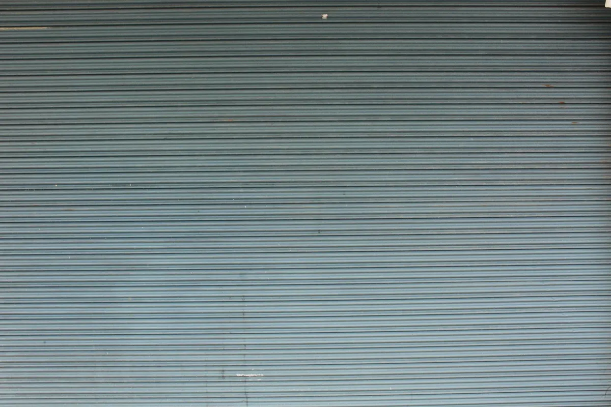 Closed gray metal garage door with horizontal panels.