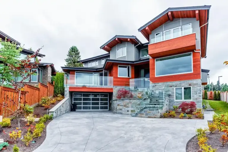 Contemporary multi-level home with an attached two-car garage, concrete driveway, and landscaped front yard